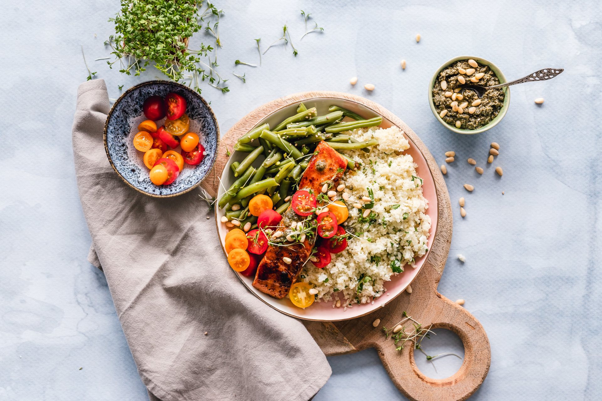 plate of salmon with rice nad green beans against a white background